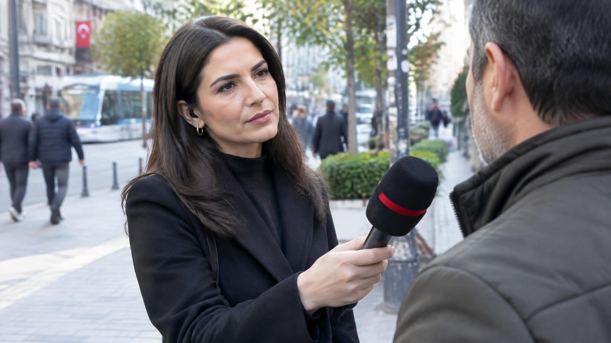 Reporter interviewing a source with a microphone